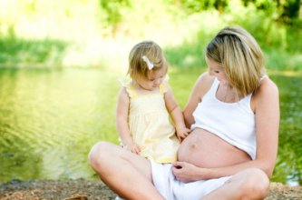 pregnant woman with daughter enjoying afternoon at the park