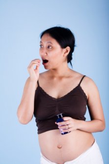 pregnancy woman taking supplements - always consult with your doctor before changing your diet or taking supplements