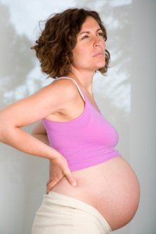 very pregnant woman suffering lower back pain