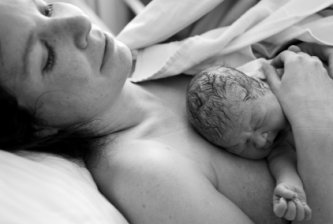 newborn and exhausted mom - baby born less than a minute from time of picture 