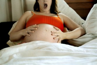surprised pregnant woman feeling her first contraction