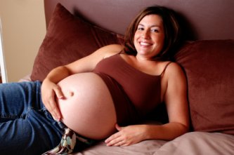 pregnant woman resting comfortably in bed